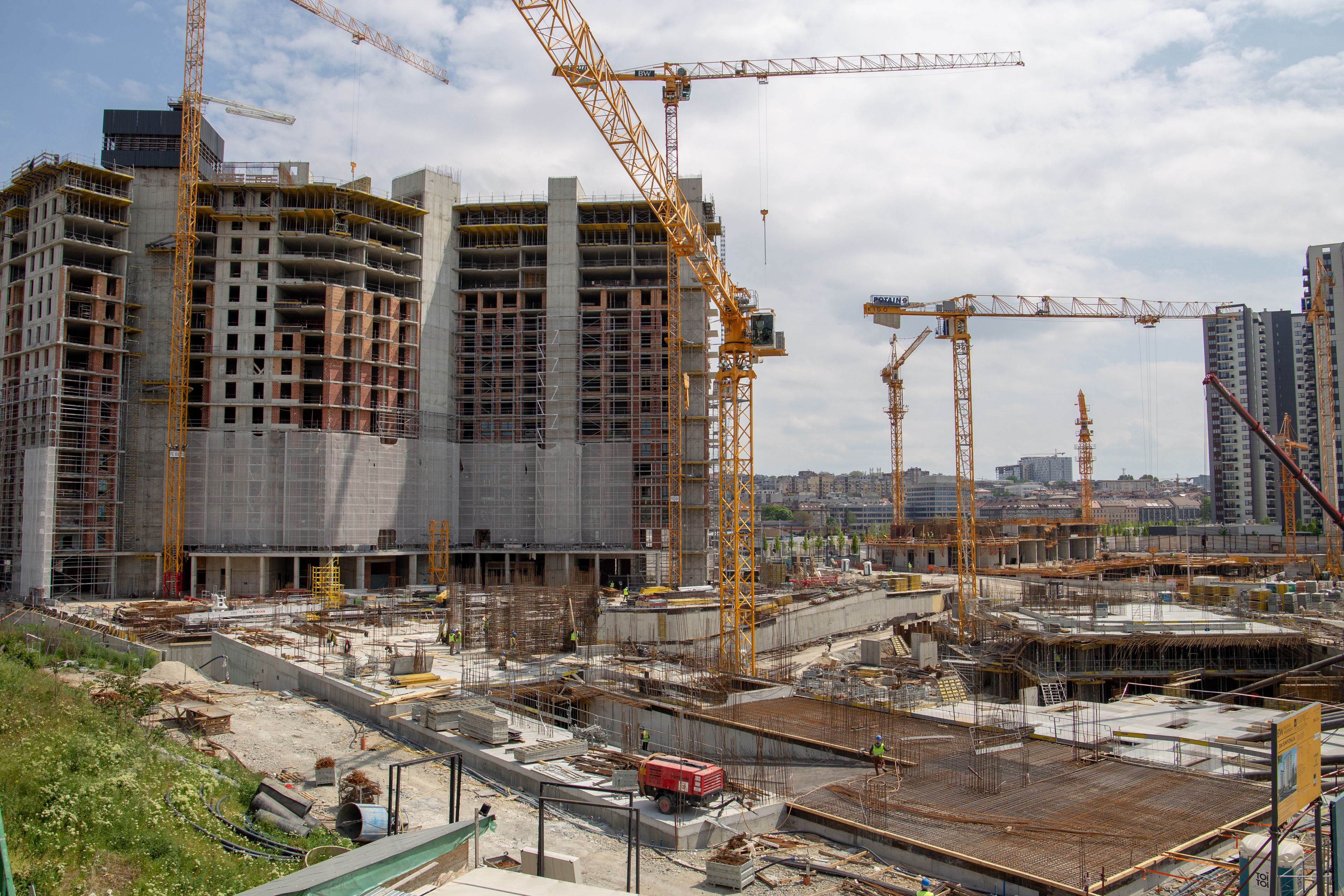 Large multi-tower construction site with tower cranes