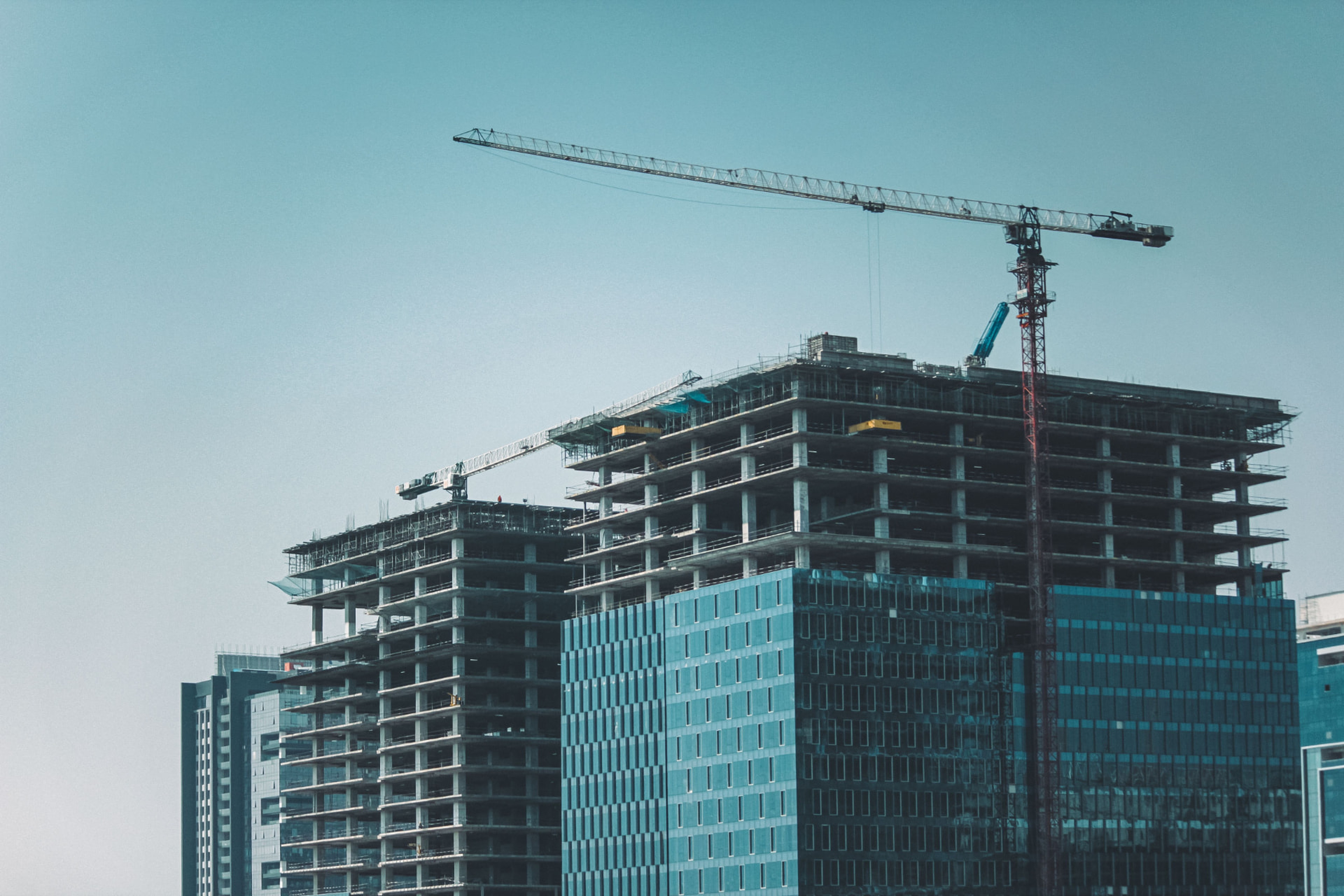 High-rise towers under construction with tower cranes